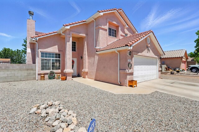 117 El Mundo Rd, Rio Communities, NM 87002 - mediterranean / spanish-style house featuring stucco siding, a tile roof, an attached garage, a chimney, and driveway