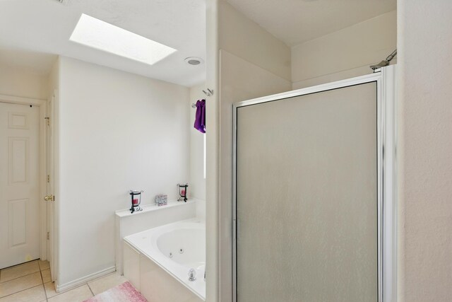 117 El Mundo Rd, Rio Communities, NM 87002 - bathroom featuring a skylight, a shower stall, tile patterned floors, and a tub with jets