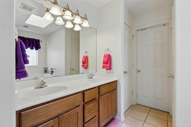117 El Mundo Rd, Rio Communities, NM 87002 - full bathroom with double vanity, tile patterned flooring, and a skylight