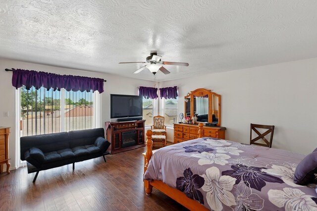 117 El Mundo Rd, Rio Communities, NM 87002 - bedroom featuring access to outside, a textured ceiling, dark wood-type flooring, and a ceiling fan