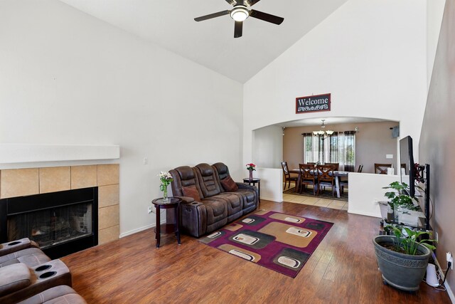117 El Mundo Rd, Rio Communities, NM 87002 - living room featuring high vaulted ceiling, a ceiling fan, a chandelier, arched walkways, and wood finished floors