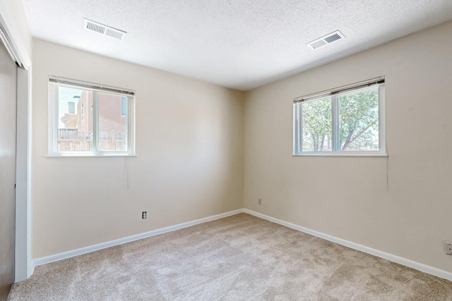 508 San Juan De Rio Dr SE, Rio Rancho, NM 87124 - unfurnished bedroom with carpet, a textured ceiling, a closet, and baseboards