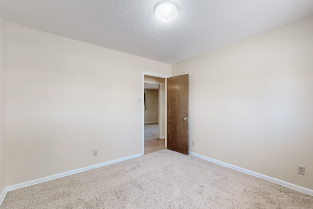508 San Juan De Rio Dr SE, Rio Rancho, NM 87124 - spare room featuring carpet floors, baseboards, and a textured ceiling