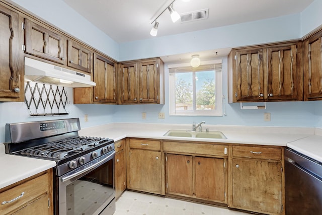 508 San Juan De Rio Dr SE, Rio Rancho, NM 87124 - kitchen featuring stainless steel gas range oven, under cabinet range hood, a sink, and light countertops