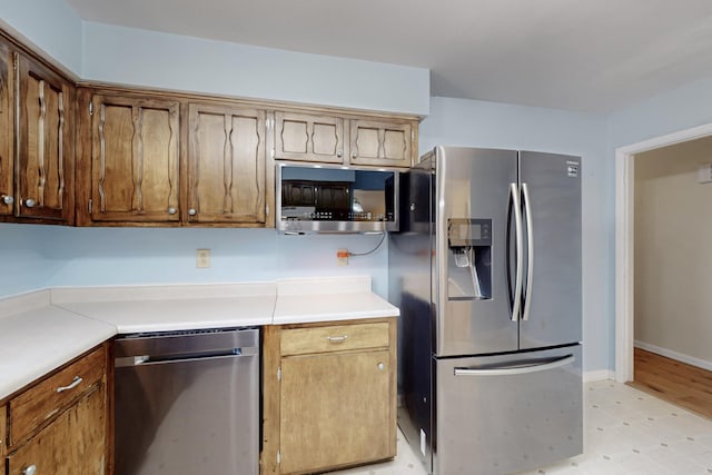 508 San Juan De Rio Dr SE, Rio Rancho, NM 87124 - kitchen with stainless steel appliances, light floors, light countertops, and brown cabinets