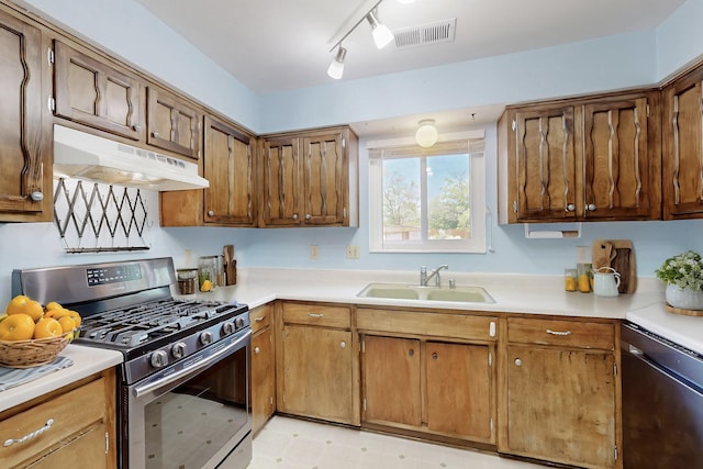 508 San Juan De Rio Dr SE, Rio Rancho, NM 87124 - kitchen featuring stainless steel gas stove, a sink, under cabinet range hood, and light countertops