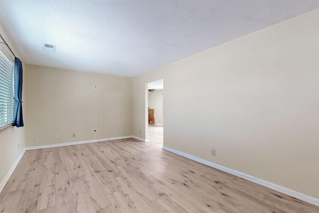 508 San Juan De Rio Dr SE, Rio Rancho, NM 87124 - unfurnished room with light wood-type flooring, a textured ceiling, and baseboards