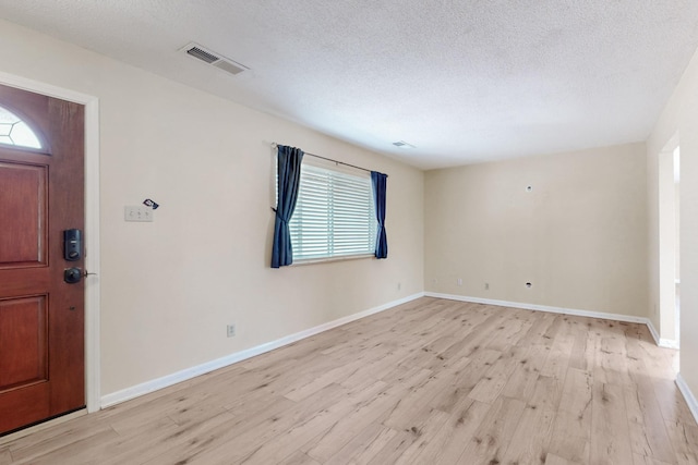 508 San Juan De Rio Dr SE, Rio Rancho, NM 87124 - entrance foyer with light wood-style flooring, plenty of natural light, a textured ceiling, and baseboards