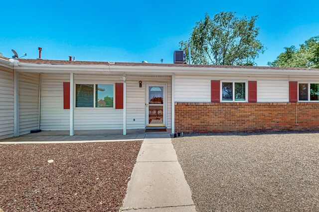 508 San Juan De Rio Dr SE, Rio Rancho, NM 87124 - single story home with brick siding, a shingled roof, and cooling unit