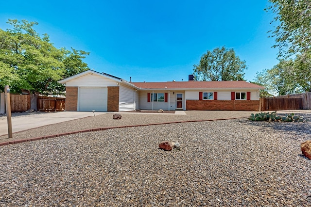 508 San Juan De Rio Dr SE, Rio Rancho, NM 87124 - single story home featuring brick siding, concrete driveway, a garage, and a chimney