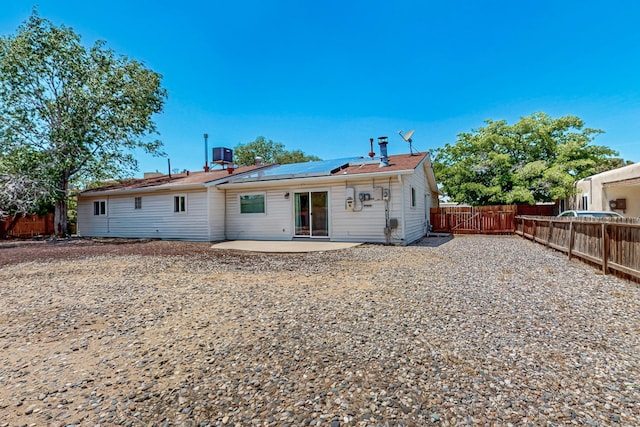 508 San Juan De Rio Dr SE, Rio Rancho, NM 87124 - rear view of house with a patio, solar panels, a fenced backyard, and central air condition unit