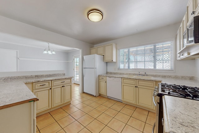 9913 Leyendecker Rd NE, Albuquerque, NM 87112 - kitchen featuring white appliances, cream cabinets, a sink, and plenty of natural light