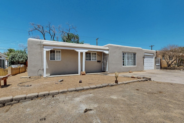9913 Leyendecker Rd NE, Albuquerque, NM 87112 - view of front of house with stucco siding, driveway, and an attached garage