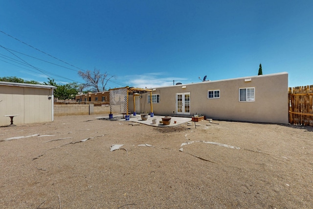 9913 Leyendecker Rd NE, Albuquerque, NM 87112 - rear view of house with stucco siding, a patio area, and french doors