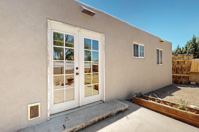 9913 Leyendecker Rd NE, Albuquerque, NM 87112 - view of exterior entry with french doors and stucco siding