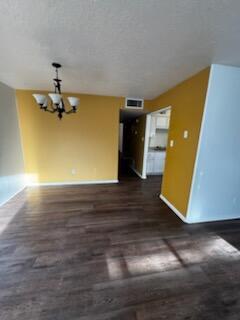 1100 10th St SW, Albuquerque, NM 87102 - unfurnished living room with baseboards, a chandelier, and dark wood finished floors
