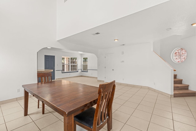 10504 W Connemara Ave SW, Albuquerque, NM 87121 - dining area with arched walkways, light tile patterned floors, stairway, and recessed lighting