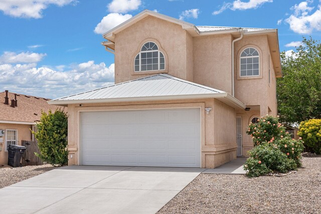 10504 W Connemara Ave SW, Albuquerque, NM 87121 - view of front facade featuring stucco siding, driveway, and a garage