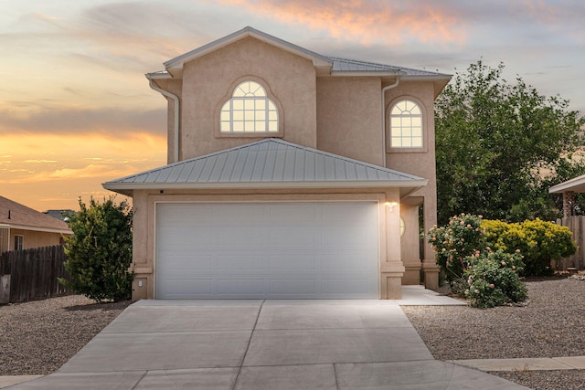 10504 W Connemara Ave SW, Albuquerque, NM 87121 - view of front of house featuring driveway, stucco siding, metal roof, and a garage
