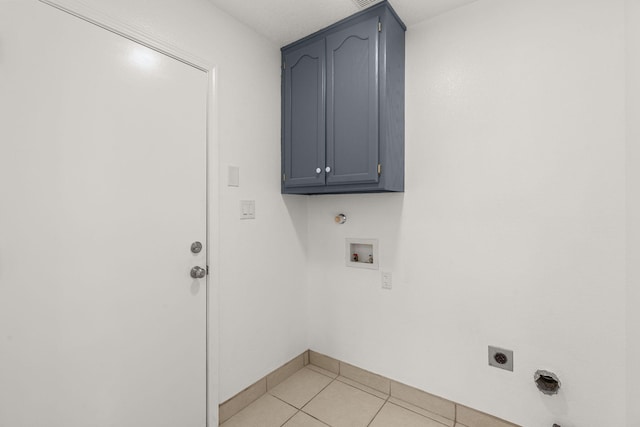 10504 W Connemara Ave SW, Albuquerque, NM 87121 - laundry area with electric dryer hookup, washer hookup, light tile patterned floors, baseboards, and cabinet space