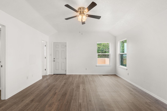 10504 W Connemara Ave SW, Albuquerque, NM 87121 - spare room with vaulted ceiling, wood finished floors, ceiling fan, baseboards, and a textured ceiling