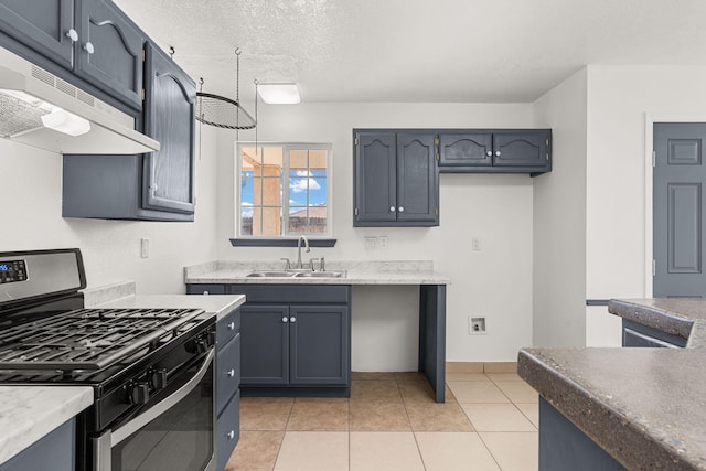 10504 W Connemara Ave SW, Albuquerque, NM 87121 - kitchen featuring stainless steel range with gas cooktop, a sink, under cabinet range hood, baseboards, and a textured ceiling