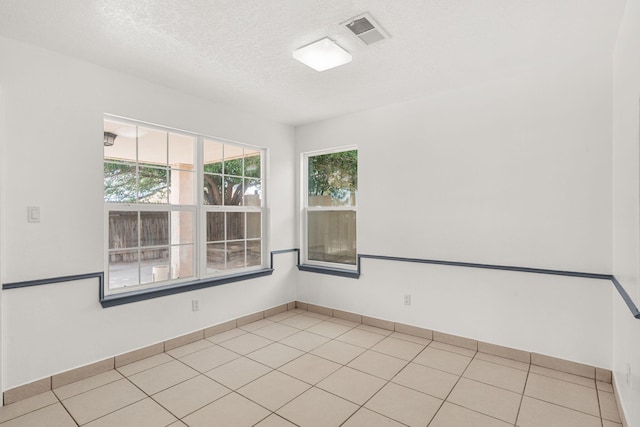10504 W Connemara Ave SW, Albuquerque, NM 87121 - spare room featuring a textured ceiling, light tile patterned floors, and baseboards