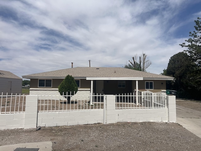 3525 Camino Alameda SW, Albuquerque, NM 87105 - view of front of home with a fenced front yard, a shingled roof, and covered porch