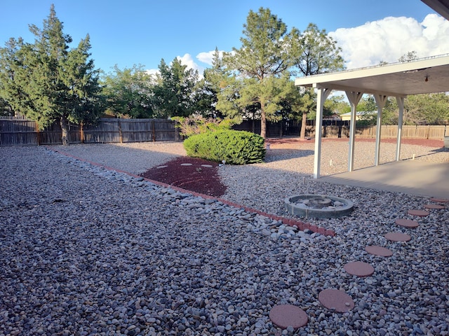 4111 El Cajon Ct SE, Rio Rancho, NM 87124 - fenced backyard featuring an outdoor fire pit and a patio area