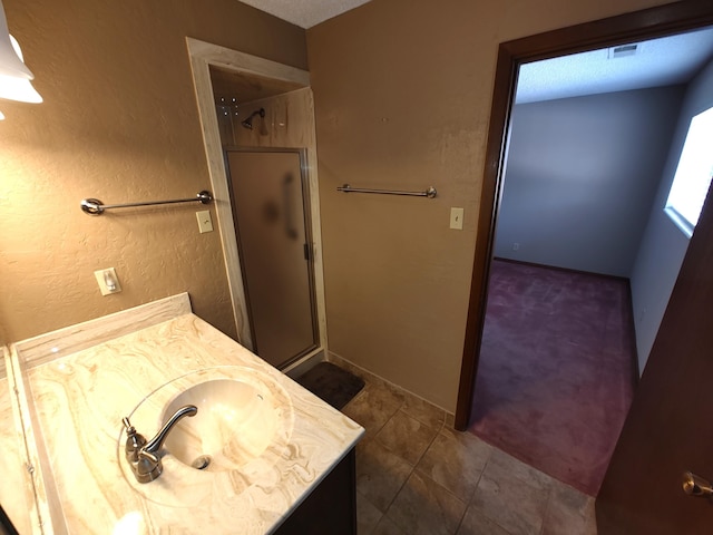 4111 El Cajon Ct SE, Rio Rancho, NM 87124 - bathroom with vanity, a shower stall, tile patterned flooring, and a textured wall