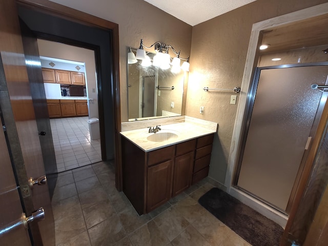 4111 El Cajon Ct SE, Rio Rancho, NM 87124 - bathroom with vanity, a textured wall, a stall shower, and tile patterned flooring
