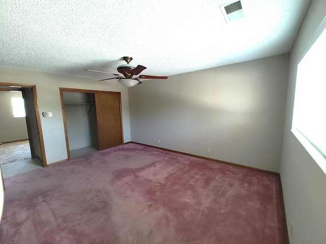 4111 El Cajon Ct SE, Rio Rancho, NM 87124 - unfurnished bedroom with carpet flooring, a closet, baseboards, and a textured ceiling