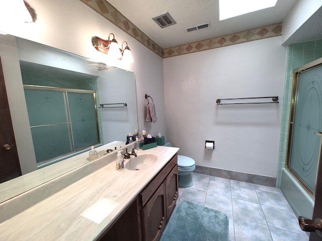 4111 El Cajon Ct SE, Rio Rancho, NM 87124 - bathroom featuring vanity, toilet, shower / bath combination with glass door, a textured ceiling, and tile patterned floors