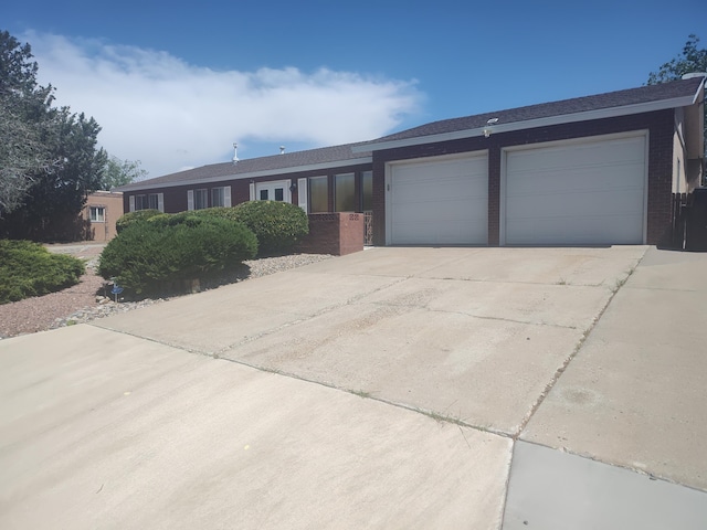 4111 El Cajon Ct SE, Rio Rancho, NM 87124 - ranch-style house featuring brick siding, driveway, and a garage