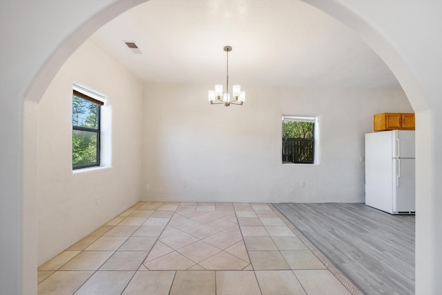 2012 Foothill Dr SW, Albuquerque, NM 87105 - unfurnished dining area featuring a chandelier and arched walkways