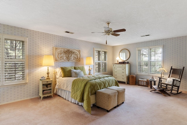 8480 Osuna Rd NE, Albuquerque, NM 87111 - carpeted bedroom featuring wallpapered walls, a textured ceiling, a ceiling fan, and baseboards