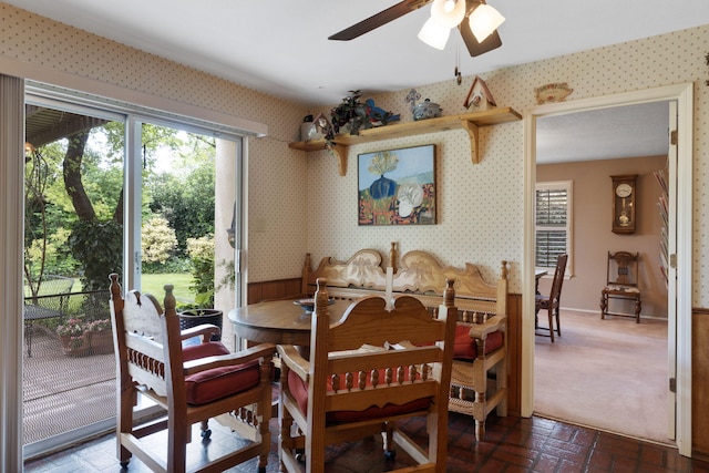 8480 Osuna Rd NE, Albuquerque, NM 87111 - dining area featuring healthy amount of natural light, a ceiling fan, brick floors, and wallpapered walls