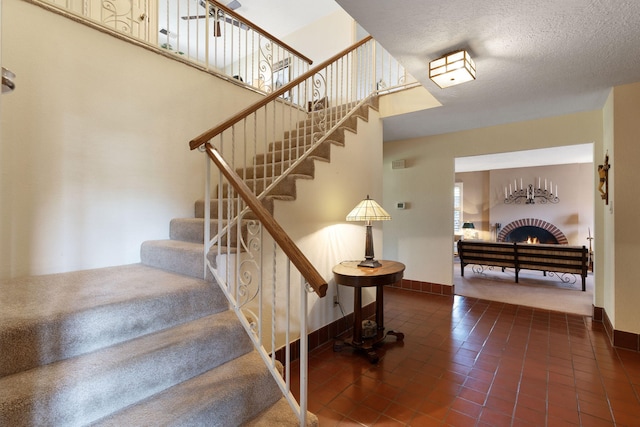 8480 Osuna Rd NE, Albuquerque, NM 87111 - stairs with tile patterned floors, a fireplace, and baseboards