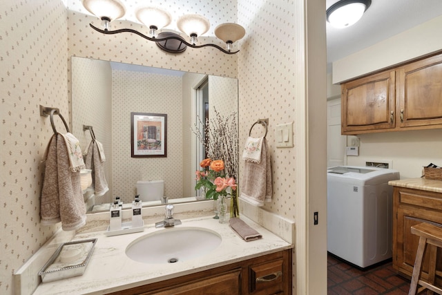 8480 Osuna Rd NE, Albuquerque, NM 87111 - bathroom with washer / clothes dryer, wallpapered walls, brick patterned flooring, and vanity