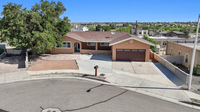 4509 Tottle Ave NW, Albuquerque, NM 87114 - view of front of house with an attached garage, concrete driveway, a residential view, and stucco siding