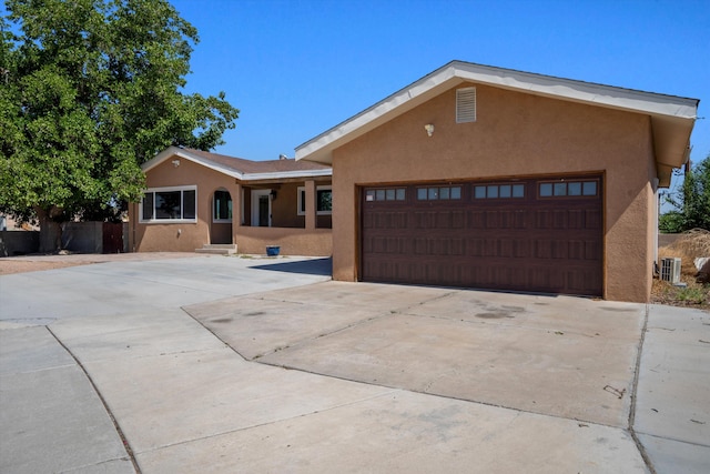 4509 Tottle Ave NW, Albuquerque, NM 87114 - view of front of property with stucco siding, concrete driveway, central AC unit, and an attached garage