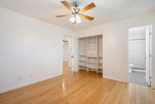 4509 Tottle Ave NW, Albuquerque, NM 87114 - unfurnished bedroom featuring light wood-type flooring, baseboards, connected bathroom, a ceiling fan, and a closet