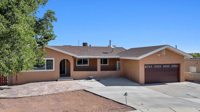 4509 Tottle Ave NW, Albuquerque, NM 87114 - view of front of home with an attached garage, stucco siding, driveway, and a shingled roof