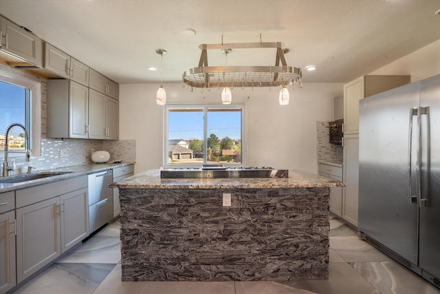 4509 Tottle Ave NW, Albuquerque, NM 87114 - kitchen featuring stainless steel appliances, a sink, gray cabinets, backsplash, and light stone counters