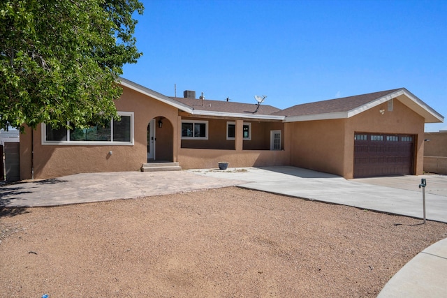 4509 Tottle Ave NW, Albuquerque, NM 87114 - view of front of house with an attached garage, stucco siding, and concrete driveway