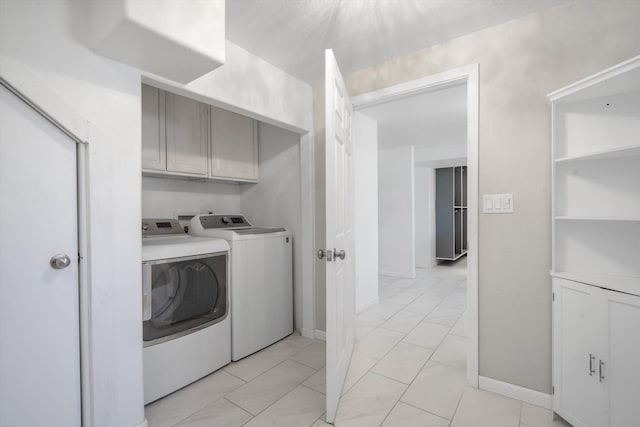 4509 Tottle Ave NW, Albuquerque, NM 87114 - laundry area featuring separate washer and dryer, cabinet space, light marble finish flooring, and baseboards