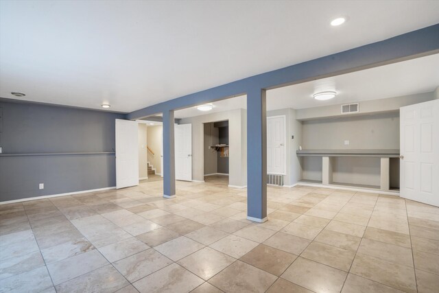 4509 Tottle Ave NW, Albuquerque, NM 87114 - finished below grade area with stairway, tile patterned flooring, and baseboards