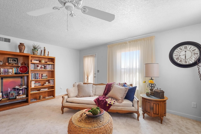 1951 Corta Rustica, Los Lunas, NM 87031 - carpeted living room featuring a ceiling fan and a textured ceiling