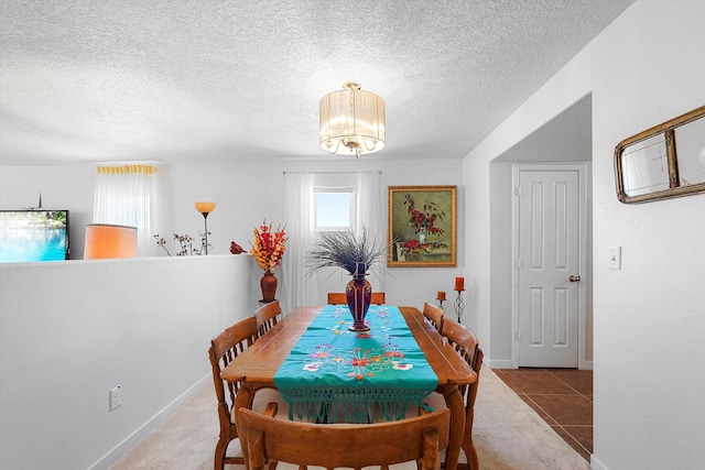 1951 Corta Rustica, Los Lunas, NM 87031 - tiled dining room with a chandelier, a textured ceiling, and carpet flooring