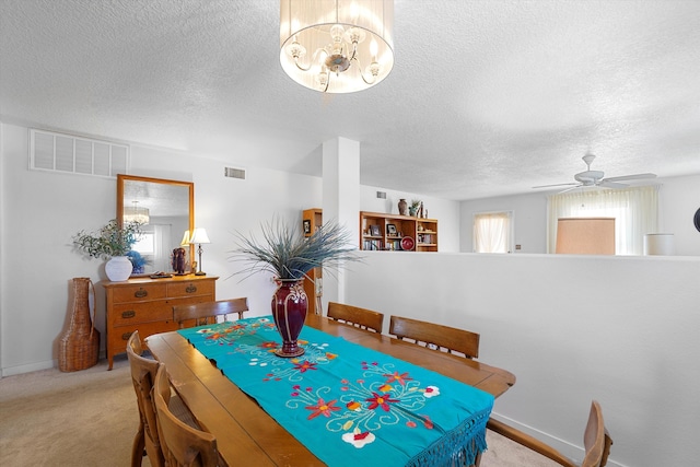 1951 Corta Rustica, Los Lunas, NM 87031 - dining room with light carpet, a chandelier, a textured ceiling, and ceiling fan
